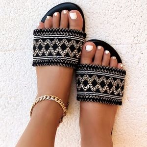 Woven slide sandal; geometric gold, black & white.